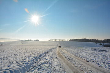 One  car on a snowy road in the country with many snow