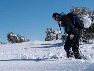 Fototapeta na wymiar BEAUTIFUL PHOTO OF A HIKING MAN ON THE SNOW