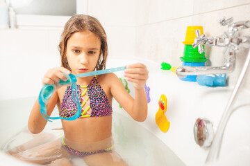 Little funny girl with blue bathing glasses