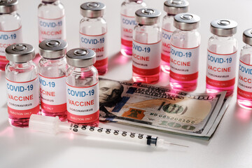 New coronavirus COVID19 infection vaccine with dollar bills and syringe on white background