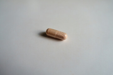 One pink vegetarian capsule of probiotics dietary supplement