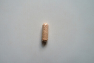 Top view of pink capsule of probiotic dietary supplement