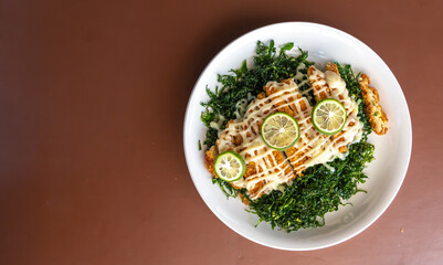 slice fried chicken wing with garlic sauce on table.