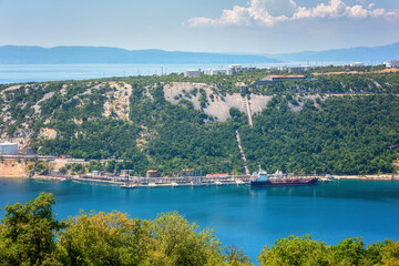 Fototapeta premium Oil refinery near Rijeka, Croatia. Summer landscape and industrial panoramic view