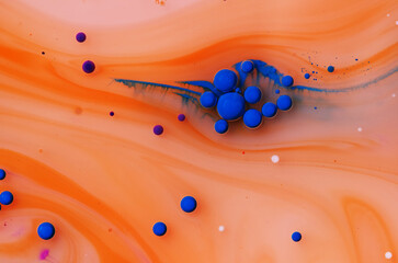abstract background oil drops on water macro orange