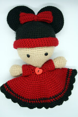 A doll made of yarn on a white background.