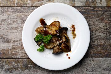 Soft focus. Eringi mushrooms on a plate with spices. Cooked eringi mushrooms.