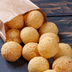 .Delicious Brazilian cheese bread coming out of a paper bag. Also known in Latin America as Chipa, Pan de Bono and Pan de Yuca.