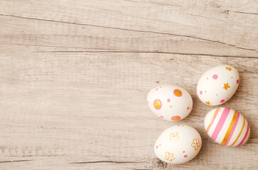 Colorful perfect handmade painted easter eggs on a wood background.