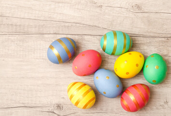 Fototapeta na wymiar Colorful perfect handmade painted easter eggs on a wood background.