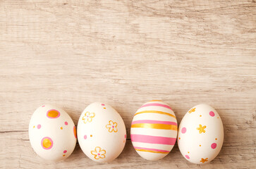 Colorful perfect handmade painted easter eggs on a wood background.