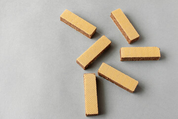 Several wafers with chocolate on a light background. Selective focus
