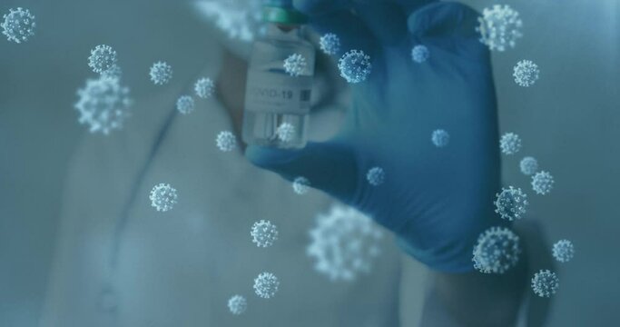 Animation of covid 19 cells and masked gloved doctor holding vaccine