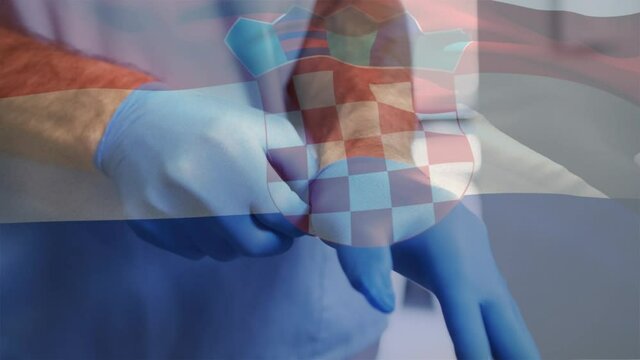 Animation of flag of croatia and doctor putting on surgical gloves