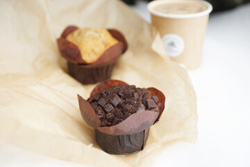 Chocolate and vanilla muffins in paper wrapper