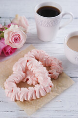 Two pink hearts made from meringues and coffee