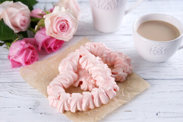Two pink hearts made from meringues and coffee