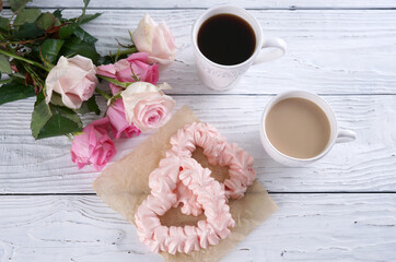 Two pink hearts made from meringues and coffee
