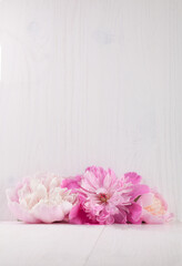 Obraz na płótnie Canvas Beautiful pink peonies on white wooden background.