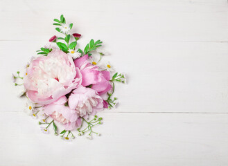 Bouquet of beautiful flowers on white wooden background. Top view. Copy space