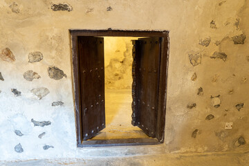 Ancient Museum open small door inside a middle eastern fort at the Ras al Khaimah Museum in the United Arab Emirates.