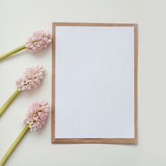 mockup with pink flowers and blank paper with copy space. 