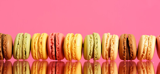 Colorful french macarons on background