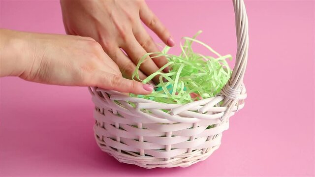 happy easter woman hand find colored eggs in wicker backet close up