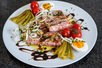 homemade brawn with eggs, cherry tomatoes, onions and pickles in olive oil and balsamic vinegar
