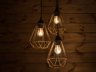Modern stylish metal lampshades with yellow LED lamp, on a wooden background. fragment of the...