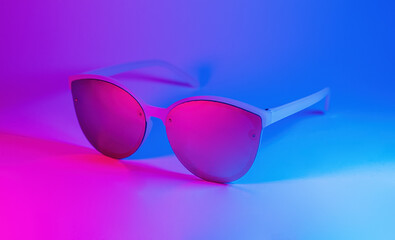 Sunglasses in vibrant bold gradient purple and blue holographic colors. Concept art. Minimal summer...