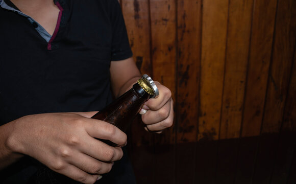 young man opening a beer: stock photo