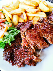 Juicy steak, beef meat with tomato and french fries