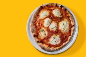 pizza with tomato sauce and mozzarella cheese and oregano in white plate isolated on yellow background.flat lay in top view with copy space