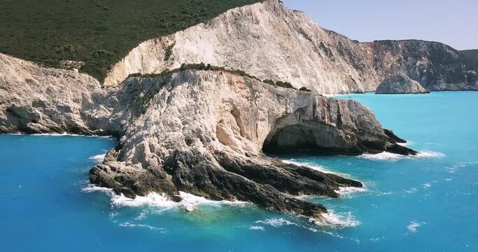 Aerial drone video of popular tropical paradise deep turquoise beach of Porto Katsiki with white steep rocky seascape and beautiful cloudy landscape, Lefkada island, Ionian, Greece