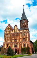 Fototapeta premium Kaliningrad Cathedral Brick Gothic-style monument sightseeing front view with beautiful clouds immanuil Kant