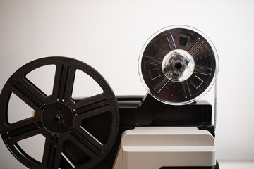 Naklejka premium Isolated 8mm projector. Antique video technology. Old retro machine for films. Filmstrip closeup