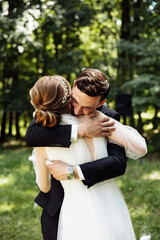 the groom and the bride read promises to each other while at the wedding ceremony. newlyweds exchange rings. groom with the bride on the background of the wedding arch.