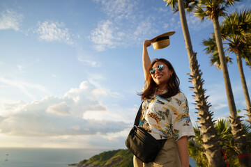 Travelers at Phromthep cape viewpoint at the south of Phuket Island, Thailand. Tropical paradise in...