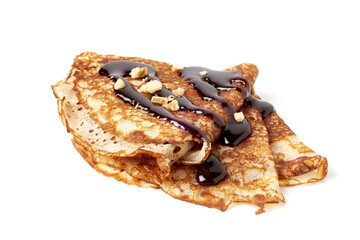 Stack of folded crepes with chocolate sauce on white