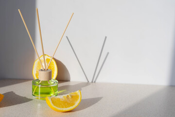 air freshener with citrus slices on a light background with sunlight and shadows. Fresh citrus scent concept for home. Copy space