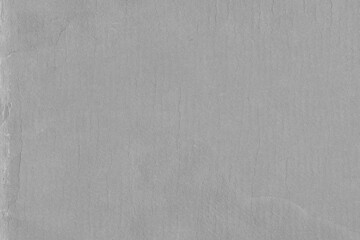 Cardboard gray texture close-up. Light old paper background. Grunge concrete wall. Vintage blank wallpaper.