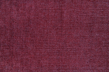 Wooly tapestry in solid garnet color, homely background with copy space, concept for home improvements, ideas for soft furnishings, one color part of a textile swatch or sample of furniture upholstery