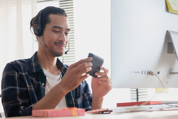 Happy young asian man celebrating birthday online feeling cheer up, surprise while show his girlfriend gift box via video call.  Valentines day on social distancing concept.