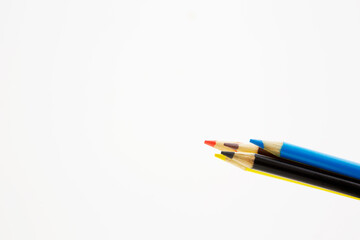 Assortment of colored pencils on white background with copy space