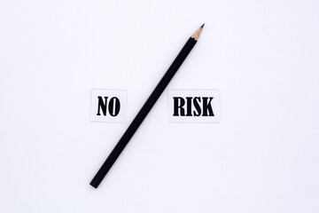 No risk words letters and a pen . Low investment risks business concept.