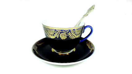 teacup with silver spoon, cobalt, gold.