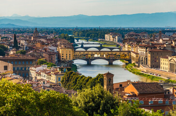 Fototapeta na wymiar Gorgeous panoramic view overlooking the bridges crossing the Arno river, including the famous medieval Ponte Vecchio of the historic city centre of Florence at dusk, seen from Piazzale Michelangelo.