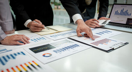 Team of business people working together in the meeting room office, teamwork background charts and...