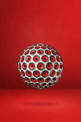 Speakers sphere on a red studio background